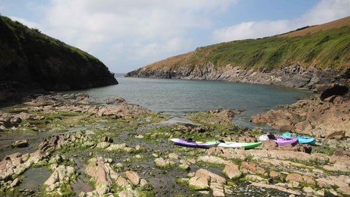 Canoes and kayaks on the beach at Port Quin, Cornwall